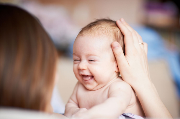 when do babies respond to smiles